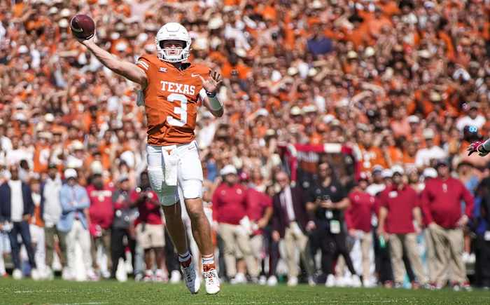 Texas Longhorns quarterback Quinn Ewers (3) passes for the touchdown in the second quarter against Oklahoma Sooners defense during an NCAA college football game at the Cotton Bowl on Saturday, Oct. 7, 2023 in Dallas, Texas.